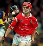 4 April 1999; Sean McGrath of Cork in action against Thomas Dunne of Tipperary during the Church & General National Hurling League Division 1B match between Tipperary and Cork at Semple Stadium in Thurles, Tipperary. Photo by Brendan Moran/Sportsfile