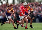 18 April 1999; Timmy McCarthy of Cork in action against Rod Guiney of Wexford during the Church & General National Hurling League Division 1B match between Wexford and Cork at Páirc Uí Shíocháin in Gorey, Wexford. Photo by Ray McManus/Sportsfile