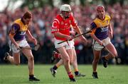 18 April 1999; Timmy McCarthy of Cork in action against Rod Guiney of Wexford during the Church & General National Hurling League Division 1B match between Wexford and Cork at Páirc Uí Shíocháin in Gorey, Wexford. Photo by Ray McManus/Sportsfile