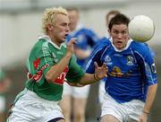 30 July 2005; Conor Mortimer, Mayo, in action against Michael Hannon, Cavan. Bank of Ireland Football Championship qualifer, Round 4. Mayo v Cavan, Dr. Hyde Park, Roscommon. Picture credit; Matt Browne / SPORTSFILE