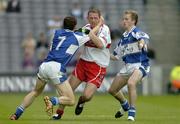 6 August 2005; Paul Murphy, Derry, is tackled by Padraig McMahon (7) and Joe Higgins, Laois. Bank of Ireland All-Ireland Senior Football Championship Qualifier, Round 4, Laois v Derry, Croke Park, Dublin. Picture credit; Brendan Moran / SPORTSFILE