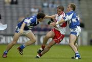 6 August 2005; Paul Murphy, Derry, is tackled by Padraig McMahon, left, and Joe Higgins, Laois. Bank of Ireland All-Ireland Senior Football Championship Qualifier, Round 4, Laois v Derry, Croke Park, Dublin. Picture credit; Brendan Moran / SPORTSFILE