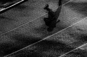 8 August 2005; The shadow of a lone athlete on the wet track during the men's 10,000m final. 2005 IAAF World Athletic Championships, Helsinki, Finland. Picture credit; Pat Murphy / SPORTSFILE