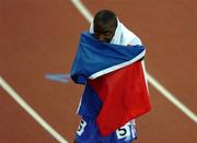 12 August 2005; Ladji Doucoure, France, wraps up in the French flag in celebration after victory in the Men's 110m Hurdles Final. 2005 IAAF World Athletic Championships, Helsinki, Finland. Picture credit; Pat Murphy / SPORTSFILE