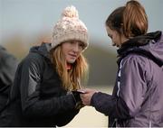 2 March 2014; Fionnuala Britton signs an autograph for Hannah Stewart, from Dundalk, during the Woodie’s DIY Inter Club & Juvenile Relay Cross Country Championships of Ireland. Dundalk Institute of Technology, Dundalk, Co. Louth. Picture credit: Matt Browne / SPORTSFILE