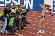 14 August 2005; Paula Radcliffe, Great Britain, stands for photographers as she celebrates victory in the Women's Marathon. 2005 IAAF World Athletic Championships, Helsinki, Finland. Picture credit; Pat Murphy / SPORTSFILE