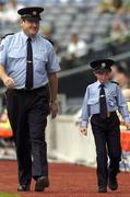 28 August 2005; David Moran, Swinford, Co. Mayo, along side Sergeant Pat Kenny, right, walk the sideline. David suffers from Leukaemia and was made a honourary member of the Gardai for a week. Bank of Ireland All-Ireland Senior Football Championship Semi-Final, Kerry v Cork, Croke Park, Dublin. Picture credit; David Maher / SPORTSFILE