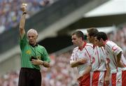 27 August 2005; Referee Gerry Kinneavy shows the yellow card to Tyrone's Shane Sweeney, centre, as team-mates Ryan McMenamin and Davy Harte look on. Bank of Ireland All-Ireland Senior Football Championship Quarter-Final Replay, Dublin v Tyrone, Croke Park, Dublin. Picture credit; Damien Eagers / SPORTSFILE