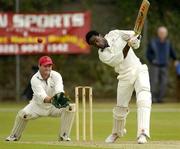 2 September 2005; Adrian Murphy, Railway Union, bats off a ball from North County bowler Dwain Harper, not pictured, as wicketkeeper Paddy Martin, left, looks on. Irish Senior Cup Final, Railway Union v North County, Castle Avenue, Clontarf, Dublin. Picture credit; Pat Murphy / SPORTSFILE