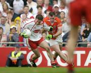 4 September 2005; Stephen O'Neill, Tyrone, is fouled by Ciaran McKeever, Armagh. The subsequent free kick was scored by Peter Canavan which won the game by one point for Tyrone. Bank of Ireland All-Ireland Senior Football Championship Semi-Final, Armagh v Tyrone, Croke Park, Dublin. Picture credit; Brendan Moran / SPORTSFILE