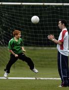 31 August 2005; Keith Browne, a member of the Clonmel Town U12 team, shows off his skills to Shelbourne's Ollie Cahill as the Clonmel Town U12 team take a  final training session before they depart to represent Ireland at the World Finals of the Danone Nations Cup at the Gerland Stadium in Lyon, home to Olympic Lyonnais. AUL Complex, Clonshaugh, Dublin. Picture credit; David Maher / SPORTSFILE