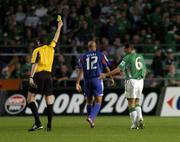 7 September 2005; Roy Keane, 6, Republic of Ireland, is shown a yellow card by referee Herbert Fandel. FIFA 2006 World Cup Qualifier, Group 4, Republic of Ireland v France, Lansdowne Road, Dublin. Picture credit; Brian Lawless / SPORTSFILE