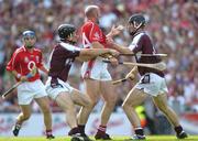 11 September 2005; Brian Corcoran, Cork, in action against Shane Kavanagh, left, and Tony Og Regan, Galway. Guinness All-Ireland Senior Hurling Championship Final, Galway v Cork, Croke Park, Dublin. Picture credit; Ray McManus / SPORTSFILE *** Local Caption *** Any photograph taken by SPORTSFILE during, or in connection with, the 2005 Guinness All-Ireland Hurling Final which displays GAA logos or contains an image or part of an image of any GAA intellectual property, or, which contains images of a GAA player/players in their playing uniforms, may only be used for editorial and non-advertising purposes.  Use of photographs for advertising, as posters or for purchase separately is strictly prohibited unless prior written approval has been obtained from the Gaelic Athletic Association.