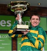 11 March 2014; Jockey Barry Geraghty lifts the Champion Hurdle trophy after victory in the Stan James Champion Hurdle Challenge Trophy on Jezki. Cheltenham Racing Festival 2014. Prestbury Park, Cheltenham, England. Picture credit: Barry Cregg / SPORTSFILE