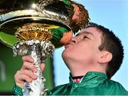11 March 2014; Jockey Barry Geraghty kisses the Champion Hurdle trophy after victory in the Stan James Champion Hurdle Challenge Trophy on Jezki. Cheltenham Racing Festival 2014. Prestbury Park, Cheltenham, England. Picture credit: Barry Cregg / SPORTSFILE