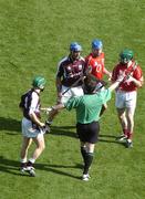 11 September 2005; Referee Seamus Roche separates Galway midfielders Fergal Healy, 8, and David Tierney, second from left, from the Cork midfield pair Tom Kenny and Jerry O'Connor, right, before the throw in. Guinness All-Ireland Senior Hurling Championship Final, Galway v Cork, Croke Park, Dublin. Picture credit; Damien Eagers / SPORTSFILE *** Local Caption *** Any photograph taken by SPORTSFILE during, or in connection with, the 2005 Guinness All-Ireland Hurling Final which displays GAA logos or contains an image or part of an image of any GAA intellectual property, or, which contains images of a GAA player/players in their playing uniforms, may only be used for editorial and non-advertising purposes.  Use of photographs for advertising, as posters or for purchase separately is strictly prohibited unless prior written approval has been obtained from the Gaelic Athletic Association.