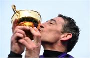 14 March 2014; Jockey Davy Russell kisses the Gold Cup after winning the BetFred Cheltenham Gold Cup Chase on Lord Windermere. Cheltenham Racing Festival 2014, Prestbury Park, Cheltenham, England. Picture credit: Barry Cregg / SPORTSFILE