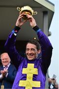 14 March 2014; Jockey Davy Russell lifts the Gold Cup after winning the BetFred Cheltenham Gold Cup Chase on Lord Windermere. Cheltenham Racing Festival 2014, Prestbury Park, Cheltenham, England. Picture credit: Barry Cregg / SPORTSFILE