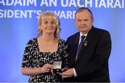 14 March 2014; Sally Young, Drom - Inch, Tipperary, is presented with her GAA President's Awards for 2014 award by Uachtarán Chumann Lúthchleas Gael Liam Ó Néill. Given her family ties to the GAA Sally Young's central role with Drom-Inch and Mid-Tipperary will come as a surprise to few. Having played camogie for the club Sally's involvement expanded as her sons grew and she assisted numerous teams before becoming club secretary. Subsequently she served as Mid Tipp Bord na nÓg PRO and Rúnaí and she is a virtual permanent fixture at games pen in hand recording match details. Picture credit: Pat Murphy / SPORTSFILE
