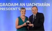 14 March 2014; Majella Smith, St Croan's, Roscommon, is presented with her GAA President's Awards for 2014 award by Uachtarán Chumann Lúthchleas Gael Liam Ó Néill. Majella Smith's lifelong involvement with the GAA started with Scór in the 1970s but has seen her progress to roles with both county and club as a widely respected and experienced administrator. After assisting her county Supporters' Club initially her Club came calling after spotting her zeal for organisation. She has been a driving force in that club's ongoing development as Rúnaí for the last 13 years. Picture credit: Pat Murphy / SPORTSFILE
