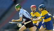 18 September 2005; Gillian McCluskey, Dublin, is tackled by Catriona McMahon and Deirdre Murphy, Clare. Dublin v Clare, All-Ireland Junior Camogie Final, Croke Park, Dublin. Picture credit; Brendan Moran / SPORTSFILE *** Local Caption *** Any photograph taken by SPORTSFILE during, or in connection with, the 2005 Guinness All-Ireland Hurling Final which displays GAA logos or contains an image or part of an image of any GAA intellectual property, or, which contains images of a GAA player/players in their playing uniforms, may only be used for editorial and non-advertising purposes.  Use of photographs for advertising, as posters or for purchase separately is strictly prohibited unless prior written approval has been obtained from the Gaelic Athletic Association.