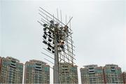 13 March 2014; Workers maintain the floodlights on bamboo scaffolding at the Hong Kong Football Club. 2014 TG4 Ladies Football All-Star Tour, Hong Kong, China. Picture credit: Brendan Moran / SPORTSFILE