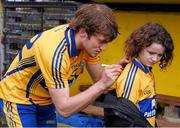 16 March 2014; Shane O'Donnell signs a shirt for eight year old Sienna Skelly, from Scarriff, Co. Clare, after the game. Allianz Hurling League, Division 1A, Round 4, Clare v Waterford, Cusack Park, Ennis, Co. Clare. Picture credit: Ray McManus / SPORTSFILE