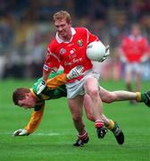 25 April 1999; Aidan Dorgan of Cork in action against John McDermott of Meath during the Church & General National Football League Division 1 Semi-Final match between Cork and Meath at Croke Park in Dublin. Photo by Ray McManus/Sportsfile