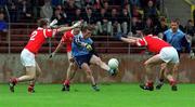 9 May 1999; Niall O'Donoghue of Dublin is surrounded by Cork players, from left, Michael O'Donovan, Anthony Lynch and Martin Cronin during the Church & General National Football League Final between Cork and Dublin at Páirc U’ Chaoimh in Cork. Photo by Aoife Rice/Sportsfile