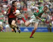 25 September 2005; Martin Clarke, Down, in action against Tom Cunniff, Mayo. ESB All-Ireland Minor Football Championship Final, Mayo v Down, Croke Park, Dublin. Picture credit; Damien Eagers/ SPORTSFILE *** Local Caption *** Any photograph taken by SPORTSFILE during, or in connection with, the 2005 ESB All-Ireland Minor Football Final which displays GAA logos or contains an image or part of an image of any GAA intellectual property, or, which contains images of a GAA player/players in their playing uniforms, may only be used for editorial and non-advertising purposes.  Use of photographs for advertising, as posters or for purchase separately is strictly prohibited unless prior written approval has been obtained from the Gaelic Athletic Association.