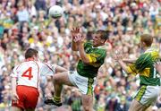 25 September 2005; Dara O'Cinneide supported by team-mate Colm Cooper, left, Kerry, in action against Michael McGee, Tyrone. Bank of Ireland All-Ireland Senior Football Championship Final, Kerry v Tyrone, Croke Park, Dublin. Picture credit; Damien Eagers/ SPORTSFILE *** Local Caption *** Any photograph taken by SPORTSFILE during, or in connection with, the 2005 Bank of Ireland All-Ireland Senior Football Final which displays GAA logos or contains an image or part of an image of any GAA intellectual property, or, which contains images of a GAA player/players in their playing uniforms, may only be used for editorial and non-advertising purposes.  Use of photographs for advertising, as posters or for purchase separately is strictly prohibited unless prior written approval has been obtained from the Gaelic Athletic Association.