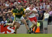 25 September 2005; Brian Dooher, Tyrone, is tackled by Seamus Moynihan, Kerry. Bank of Ireland All-Ireland Senior Football Championship Final, Kerry v Tyrone, Croke Park, Dublin. Picture credit; Ray McManus / SPORTSFILE *** Local Caption *** Any photograph taken by SPORTSFILE during, or in connection with, the 2005 Bank of Ireland All-Ireland Senior Football Final which displays GAA logos or contains an image or part of an image of any GAA intellectual property, or, which contains images of a GAA player/players in their playing uniforms, may only be used for editorial and non-advertising purposes.  Use of photographs for advertising, as posters or for purchase separately is strictly prohibited unless prior written approval has been obtained from the Gaelic Athletic Association.