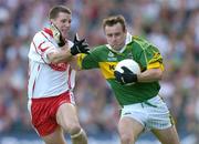 25 September 2005; William Kirby, Kerry, in action against Colin Holmes, Tyrone. Bank of Ireland All-Ireland Senior Football Championship Final, Kerry v Tyrone, Croke Park, Dublin. Picture credit; Brendan Moran / SPORTSFILE *** Local Caption *** Any photograph taken by SPORTSFILE during, or in connection with, the 2005 Bank of Ireland All-Ireland Senior Football Final which displays GAA logos or contains an image or part of an image of any GAA intellectual property, or, which contains images of a GAA player/players in their playing uniforms, may only be used for editorial and non-advertising purposes.  Use of photographs for advertising, as posters or for purchase separately is strictly prohibited unless prior written approval has been obtained from the Gaelic Athletic Association.