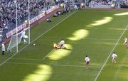 25 September 2005; Dara O Cinneide, Kerry, scores his sides first goal despite the challenge of goalkeeper Pascal McConnell and Michael McGee (4), Tyrone. Bank of Ireland All-Ireland Senior Football Championship Final, Kerry v Tyrone, Croke Park, Dublin. Picture credit; Matt Browne / SPORTSFILE *** Local Caption *** Any photograph taken by SPORTSFILE during, or in connection with, the 2005 Bank of Ireland All-Ireland Senior Football Final which displays GAA logos or contains an image or part of an image of any GAA intellectual property, or, which contains images of a GAA player/players in their playing uniforms, may only be used for editorial and non-advertising purposes.  Use of photographs for advertising, as posters or for purchase separately is strictly prohibited unless prior written approval has been obtained from the Gaelic Athletic Association.