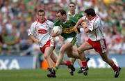 25 September 2005; Seamus Moynihan, Kerry, in action against Brian McGuigan, left, and Davy Harte, Tyrone. Bank of Ireland All-Ireland Senior Football Championship Final, Kerry v Tyrone, Croke Park, Dublin. Picture credit; Brendan Moran / SPORTSFILE *** Local Caption *** Any photograph taken by SPORTSFILE during, or in connection with, the 2005 Bank of Ireland All-Ireland Senior Football Final which displays GAA logos or contains an image or part of an image of any GAA intellectual property, or, which contains images of a GAA player/players in their playing uniforms, may only be used for editorial and non-advertising purposes.  Use of photographs for advertising, as posters or for purchase separately is strictly prohibited unless prior written approval has been obtained from the Gaelic Athletic Association.