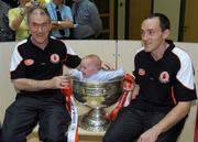 26 September 2005; Tyrone manager Mickey Harte, left, and captain Brian Dooher with patient Craig Delaney, aged 12 months from Kildare town, with the Sam Maguire cup at Our Lady's Hospital for Sick Children, Crumlin, Dublin. Picture credit; Damien Eagers/ SPORTSFILE