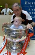 26 September 2005; Tyrone manager Mickey Harte with patient Craig Delaney, aged 12 months from Kildare town, with the Sam Maguire cup at Our Lady's Hospital for Sick Children, Crumlin, Dublin. Picture credit; Damien Eagers/ SPORTSFILE