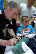 26 September 2005; Tyrone manager Mickey Harte signs the plaster of Darren Magee, from NewtownmountKennedy, Co. Wicklow, at Our Lady's Hospital for Sick Children, Crumlin, Dublin. Picture credit; Damien Eagers/ SPORTSFILE
