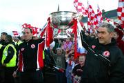 26 September 2005; Tyrone captain Brian Dooher, left, and manager Mickey Harte lift the Sam Maguire cup at the victorious Tyrone team's homecoming. Aughnacloy, Co. Tyrone. Picture credit; Oliver McVeigh / SPORTSFILE