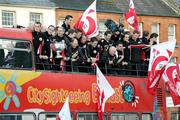 26 September 2005; The Tyrone squad and manager Mickey Harte holding the Sam Maguire Cup, salute their supporters at the victorious Tyrone team's homecoming. Aughnacloy, Co. Tyrone. Picture credit; Oliver McVeigh / SPORTSFILE