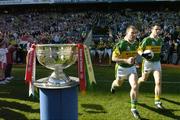 25 September 2005; Kerry players, including Dara O Cinneide, left, and William Kirby, make their way past the Sam Maguire Cup and out onto the pitch before the game. Bank of Ireland All-Ireland Senior Football Championship Final, Kerry v Tyrone, Croke Park, Dublin. Picture credit; Brendan Moran / SPORTSFILE *** Local Caption *** Any photograph taken by SPORTSFILE during, or in connection with, the 2005 Bank of Ireland All-Ireland Senior Football Final which displays GAA logos or contains an image or part of an image of any GAA intellectual property, or, which contains images of a GAA player/players in their playing uniforms, may only be used for editorial and non-advertising purposes.  Use of photographs for advertising, as posters or for purchase separately is strictly prohibited unless prior written approval has been obtained from the Gaelic Athletic Association.