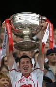25 September 2005; Tyrone's Sean Cavanagh lifts the Sam Maguire Cup after the game. Bank of Ireland All-Ireland Senior Football Championship Final, Kerry v Tyrone, Croke Park, Dublin. Picture credit; Brendan Moran / SPORTSFILE *** Local Caption *** Any photograph taken by SPORTSFILE during, or in connection with, the 2005 Bank of Ireland All-Ireland Senior Football Final which displays GAA logos or contains an image or part of an image of any GAA intellectual property, or, which contains images of a GAA player/players in their playing uniforms, may only be used for editorial and non-advertising purposes.  Use of photographs for advertising, as posters or for purchase separately is strictly prohibited unless prior written approval has been obtained from the Gaelic Athletic Association.