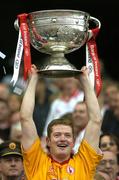 25 September 2005; Tyrone's goalkeeper Pascal McConnell lifts the Sam Maguire Cup after the game. Bank of Ireland All-Ireland Senior Football Championship Final, Kerry v Tyrone, Croke Park, Dublin. Picture credit; Brendan Moran / SPORTSFILE *** Local Caption *** Any photograph taken by SPORTSFILE during, or in connection with, the 2005 Bank of Ireland All-Ireland Senior Football Final which displays GAA logos or contains an image or part of an image of any GAA intellectual property, or, which contains images of a GAA player/players in their playing uniforms, may only be used for editorial and non-advertising purposes.  Use of photographs for advertising, as posters or for purchase separately is strictly prohibited unless prior written approval has been obtained from the Gaelic Athletic Association.
