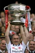 25 September 2005; Tyrone manager Mickey Harte lifts the Sam Maguire Cup after the game. Bank of Ireland All-Ireland Senior Football Championship Final, Kerry v Tyrone, Croke Park, Dublin. Picture credit; Brendan Moran / SPORTSFILE *** Local Caption *** Any photograph taken by SPORTSFILE during, or in connection with, the 2005 Bank of Ireland All-Ireland Senior Football Final which displays GAA logos or contains an image or part of an image of any GAA intellectual property, or, which contains images of a GAA player/players in their playing uniforms, may only be used for editorial and non-advertising purposes.  Use of photographs for advertising, as posters or for purchase separately is strictly prohibited unless prior written approval has been obtained from the Gaelic Athletic Association.