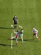 25 September 2005; Referee Michael Monahan throws the ball in between Kerry's Darragh O'Se and Tyrone's Enda McGinley as Sean Cavanagh, Tyrone, awaits the breaking ball. Bank of Ireland All-Ireland Senior Football Championship Final, Kerry v Tyrone, Croke Park, Dublin. Picture credit; Damien Eagers/ SPORTSFILE *** Local Caption *** Any photograph taken by SPORTSFILE during, or in connection with, the 2005 Bank of Ireland All-Ireland Senior Football Final which displays GAA logos or contains an image or part of an image of any GAA intellectual property, or, which contains images of a GAA player/players in their playing uniforms, may only be used for editorial and non-advertising purposes.  Use of photographs for advertising, as posters or for purchase separately is strictly prohibited unless prior written approval has been obtained from the Gaelic Athletic Association.