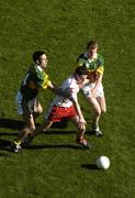 25 September 2005; Conor Gormley, Tyrone, in action against Declan O'Sullivan, left, and Liam Hassett, Kerry. Bank of Ireland All-Ireland Senior Football Championship Final, Kerry v Tyrone, Croke Park, Dublin. Picture credit; Damien Eagers/ SPORTSFILE *** Local Caption *** Any photograph taken by SPORTSFILE during, or in connection with, the 2005 Bank of Ireland All-Ireland Senior Football Final which displays GAA logos or contains an image or part of an image of any GAA intellectual property, or, which contains images of a GAA player/players in their playing uniforms, may only be used for editorial and non-advertising purposes.  Use of photographs for advertising, as posters or for purchase separately is strictly prohibited unless prior written approval has been obtained from the Gaelic Athletic Association.