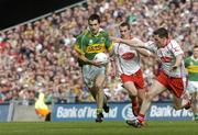25 September 2005; Tom O'Sullivan, Kerry, in action against Conor Gormley, right, and Brian McGuigan,Tyrone. Bank of Ireland All-Ireland Senior Football Championship Final, Kerry v Tyrone, Croke Park, Dublin. Picture credit; Damien Eagers/ SPORTSFILE *** Local Caption *** Any photograph taken by SPORTSFILE during, or in connection with, the 2005 Bank of Ireland All-Ireland Senior Football Final which displays GAA logos or contains an image or part of an image of any GAA intellectual property, or, which contains images of a GAA player/players in their playing uniforms, may only be used for editorial and non-advertising purposes.  Use of photographs for advertising, as posters or for purchase separately is strictly prohibited unless prior written approval has been obtained from the Gaelic Athletic Association.