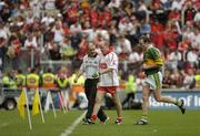 25 September 2005; Mickey Harte, Tyrone manager speaks to Tyrone's Peter Canavan as he makes his way off the pitch at half time as Kerry 's Seamus Moynihan runs by. Bank of Ireland All-Ireland Senior Football Championship Final, Kerry v Tyrone, Croke Park, Dublin. Picture credit; Damien Eagers/ SPORTSFILE *** Local Caption *** Any photograph taken by SPORTSFILE during, or in connection with, the 2005 Bank of Ireland All-Ireland Senior Football Final which displays GAA logos or contains an image or part of an image of any GAA intellectual property, or, which contains images of a GAA player/players in their playing uniforms, may only be used for editorial and non-advertising purposes.  Use of photographs for advertising, as posters or for purchase separately is strictly prohibited unless prior written approval has been obtained from the Gaelic Athletic Association.