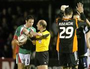 29 September 2005; Referee Phillippe Leuba, shows his watch to Alan Bennett, Cork City, at the end of the game. UEFA Cup, First Round, Second Leg, Cork City v Slavia Prague, Turners Cross, Cork. Picture credit: David Maher / SPORTSFILE