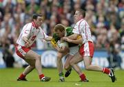 25 September 2005; Liam Hassett, Kerry, in action against Ryan Mellon, left, and Philip Jordan, Tyrone. Bank of Ireland All-Ireland Senior Football Championship Final, Kerry v Tyrone, Croke Park, Dublin. Picture credit; Brendan Moran / SPORTSFILE *** Local Caption *** Any photograph taken by SPORTSFILE during, or in connection with, the 2005 Bank of Ireland All-Ireland Senior Football Final which displays GAA logos or contains an image or part of an image of any GAA intellectual property, or, which contains images of a GAA player/players in their playing uniforms, may only be used for editorial and non-advertising purposes.  Use of photographs for advertising, as posters or for purchase separately is strictly prohibited unless prior written approval has been obtained from the Gaelic Athletic Association.